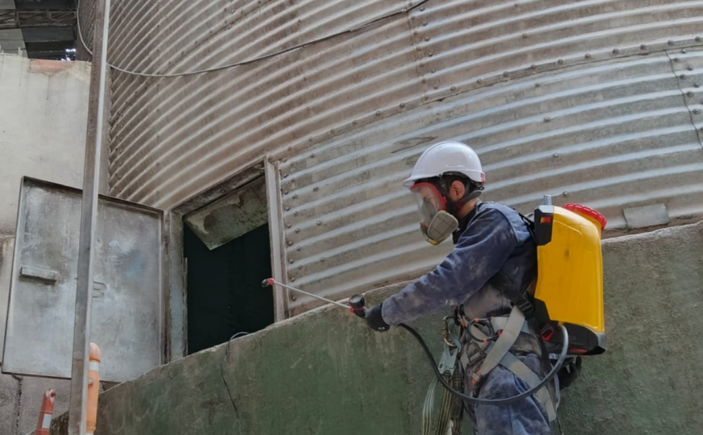 Técnico de Master Fumigaciones realizando un tratamiento en una instalación industrial
